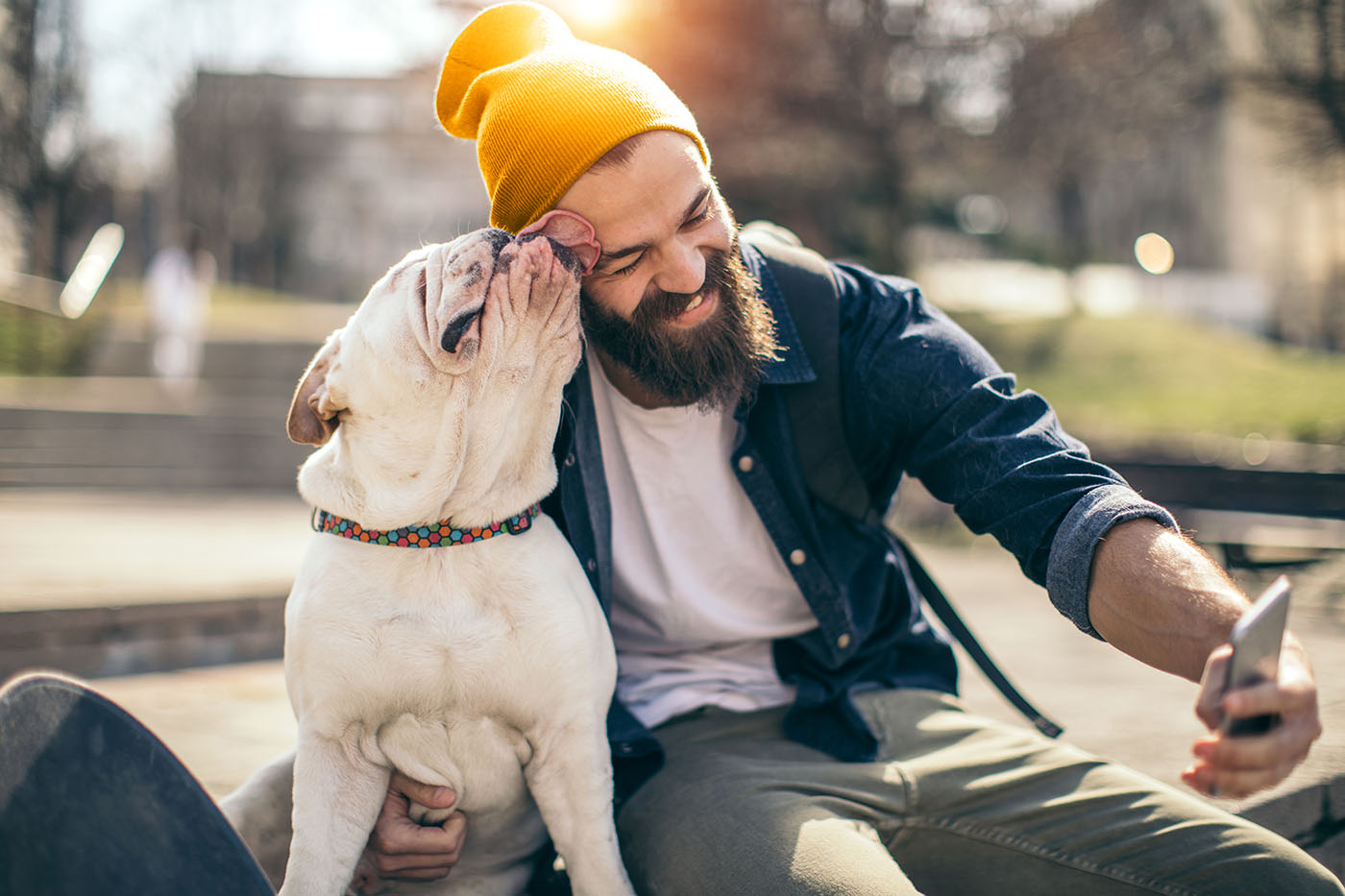 Mann mit Hund freut sich über den Gesundheitsbonus der BAHN-BKK